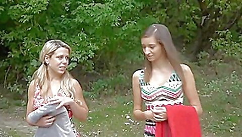 Two girlfriends walking in forest and meeting a guy